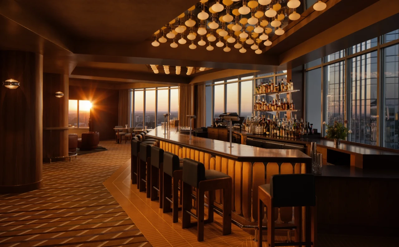 The High Ground Lounge bar glowing under golden pendant lights at sunset