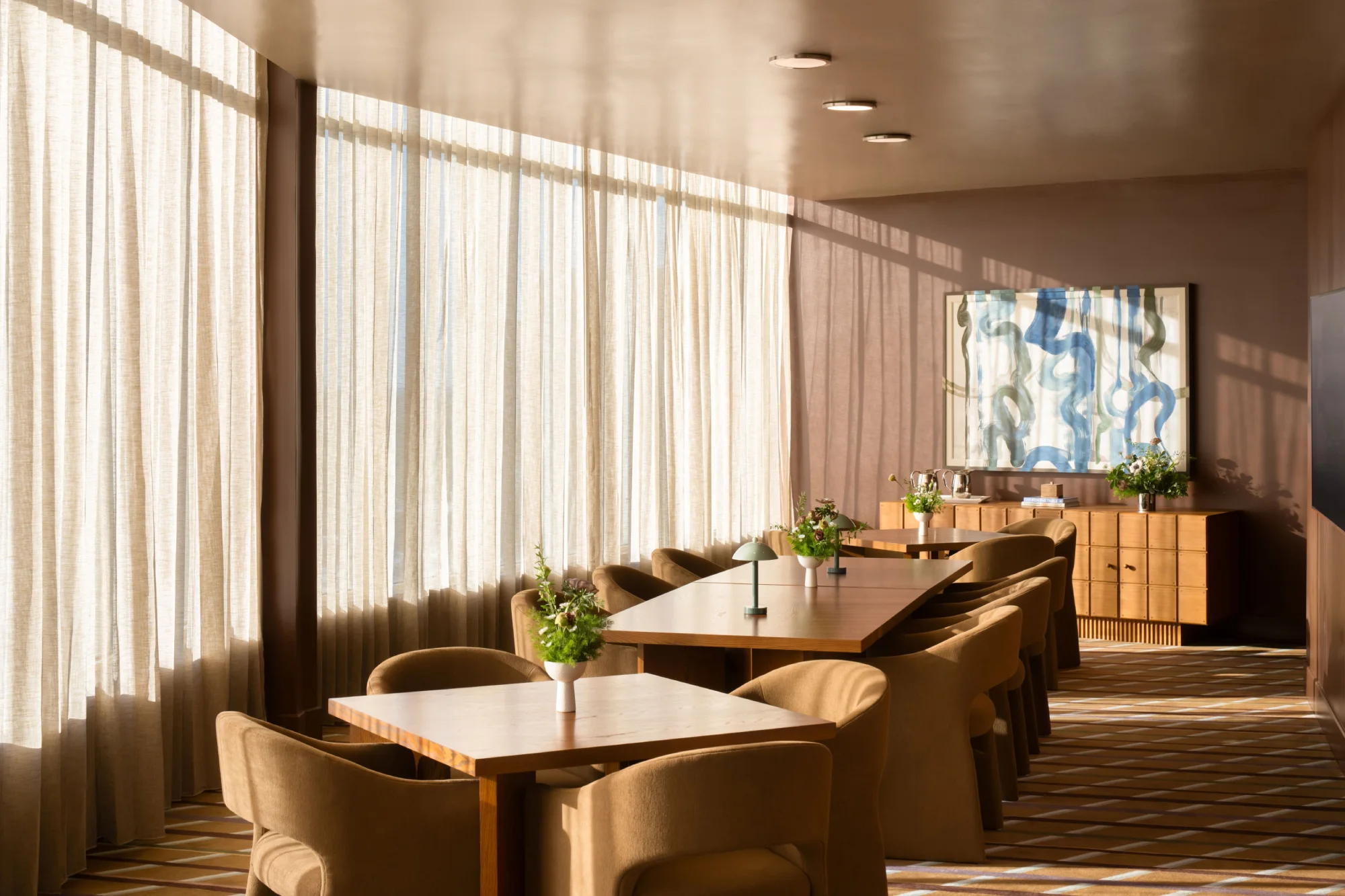 The Edenton Room set for a private dinner along the curved window line at High Ground Lounge