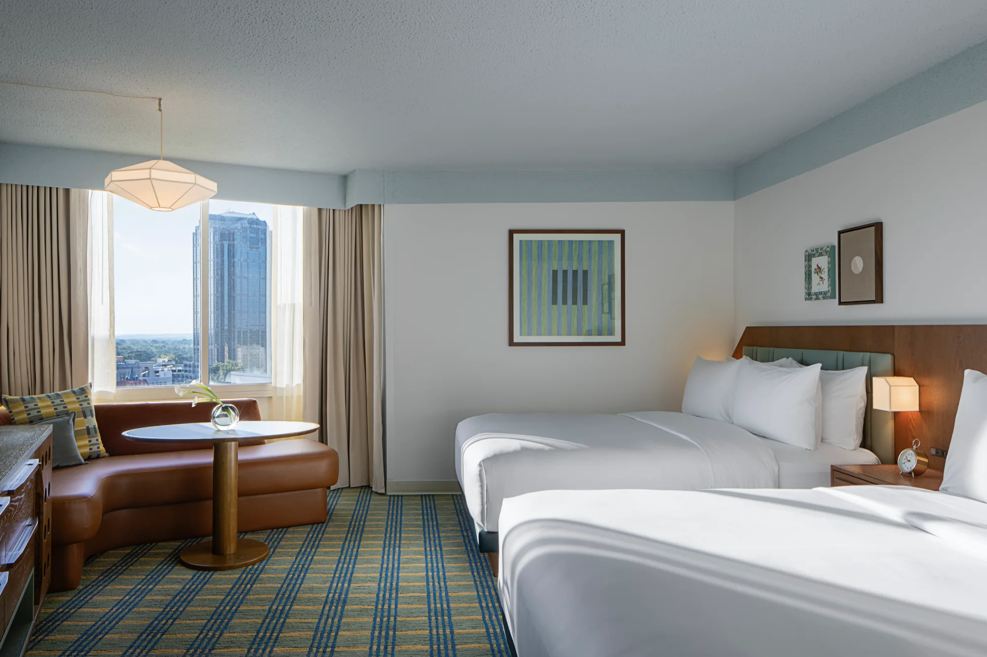 Guest room with two queen beds and city views